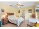 A cozy bedroom with a ceiling fan, adjacent to a desk, offering comfort and functionality at 201 Garden Ln, Longwood, FL 32750