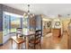 Bright dining area with wallpaper and a chandelier situated between the kitchen and backyard views at 201 Garden Ln, Longwood, FL 32750