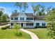 Charming two-story home with a covered front porch and well-manicured lawn at 201 Garden Ln, Longwood, FL 32750
