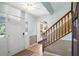 Bright foyer with tile flooring, staircase, and natural light from the front door at 201 Garden Ln, Longwood, FL 32750
