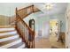 Spacious foyer with staircase, neutral walls, and view into the bedroom and closet at 201 Garden Ln, Longwood, FL 32750
