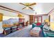 Cozy living room with a brick fireplace, ceiling fans, and comfortable seating at 201 Garden Ln, Longwood, FL 32750