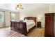 The main bedroom features a large wood bed set and matching wood furniture at 201 Garden Ln, Longwood, FL 32750