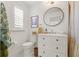 Clean bathroom featuring a toilet, vanity, framed mirror, and a shower with patterned curtain at 2036 Brink Aly, Orlando, FL 32814
