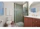 Modern bathroom with green tiled shower, colorful tile floor, cherry vanity, and decorative fixtures at 2036 Brink Aly, Orlando, FL 32814