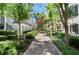 A well-maintained walkway with lush greenery leading to a row of elegant townhouses at 2036 Brink Aly, Orlando, FL 32814