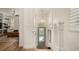 Bright hallway with wood floors, stylish chandelier, and a view into the cozy living area at 2036 Brink Aly, Orlando, FL 32814