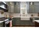 Upgraded kitchen showcasing a farmhouse sink, stainless appliances, and modern cabinetry at 2036 Brink Aly, Orlando, FL 32814