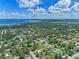 Aerial shot of a quaint residential area showcasing a property outlined in red, nestled amongst lush greenery at 205 9Th St, St Cloud, FL 34769