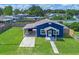 Aerial view of charming blue house with carport and fenced yard at 205 9Th St, St Cloud, FL 34769