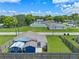 This aerial view highlights the home and its backyard, as well as other homes in the neighborhood at 205 9Th St, St Cloud, FL 34769