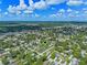 Aerial perspective of a cozy neighborhood marked by a green pin, surrounded by well-kept lawns and mature trees at 205 9Th St, St Cloud, FL 34769