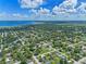 Expansive aerial view of a residential neighborhood near a serene body of water under a partly cloudy sky at 205 9Th St, St Cloud, FL 34769