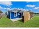 A view of the backyard showing an area for trash cans at 205 9Th St, St Cloud, FL 34769