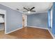 Bedroom with new flooring, neutral paint, ceiling fan, and access to the closet and bathroom at 205 9Th St, St Cloud, FL 34769