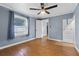 Bedroom features new flooring, neutral paint, a ceiling fan, and closet at 205 9Th St, St Cloud, FL 34769
