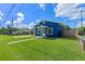This blue home has a grassy lawn and a white trimmed front door at 205 9Th St, St Cloud, FL 34769