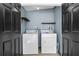 Bright Laundry room features side by side washer and dryer, shelving, and a painted floor at 205 9Th St, St Cloud, FL 34769
