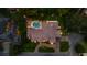 Aerial view of an estate-style home with a grand circular driveway and meticulously landscaped grounds and a pool at 2211 Azalea Pl, Winter Park, FL 32789