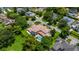 Aerial view of sprawling property with lush lawn, circular driveway and beautiful backyard pool at 2211 Azalea Pl, Winter Park, FL 32789