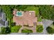 Birds eye view of a large home and manicured lawn, and a backyard pool with cabana at 2211 Azalea Pl, Winter Park, FL 32789