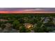 A high altitude aerial view of an estate home situated amongst lush green trees at sunset at 2211 Azalea Pl, Winter Park, FL 32789
