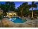 Inviting backyard with a pool, hot tub, outdoor kitchen, and a lounge area perfect for entertaining at 2211 Azalea Pl, Winter Park, FL 32789