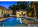 Beautiful backyard featuring a sparkling pool, hot tub, and outdoor kitchen with bar seating and poolside loungers at 2211 Azalea Pl, Winter Park, FL 32789