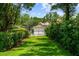Lush backyard path leading to a private boathouse on the water at 2211 Azalea Pl, Winter Park, FL 32789