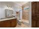 Bathroom featuring granite counters, tiled walls, and a tub with a shower at 2211 Azalea Pl, Winter Park, FL 32789
