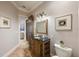 Elegant powder room featuring a carved vanity with granite countertop and decorative mirror at 2211 Azalea Pl, Winter Park, FL 32789