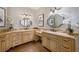 This bathroom has dual vanities and ornate framed mirrors with decorative light fixtures at 2211 Azalea Pl, Winter Park, FL 32789