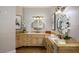 Bathroom featuring dual sinks, framed mirrors, granite countertops, and decorative light fixtures at 2211 Azalea Pl, Winter Park, FL 32789