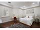 Bright bedroom with a plush bed, a decorative rug, and a vanity area under the window at 2211 Azalea Pl, Winter Park, FL 32789