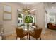 Bright breakfast nook with a glass table and chairs overlooking the pool and outdoor area at 2211 Azalea Pl, Winter Park, FL 32789