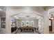 Spacious dining room with travertine floors, arched entryways, and contemporary light fixture at 2211 Azalea Pl, Winter Park, FL 32789