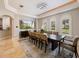 Formal dining room with a modern light fixture, large windows, and seating for ten at 2211 Azalea Pl, Winter Park, FL 32789