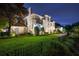 Exterior facade of the home with a manicured yard and black metal fence at 2211 Azalea Pl, Winter Park, FL 32789