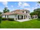 Spacious home with a large backyard, outdoor seating, and lush landscaping at 2211 Azalea Pl, Winter Park, FL 32789