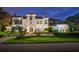 Exterior facade of the home at twilight with a manicured yard and address marker at 2211 Azalea Pl, Winter Park, FL 32789