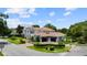 Luxurious home with a porte cochere, pristine landscaping, and gated access, creating a private retreat at 2211 Azalea Pl, Winter Park, FL 32789