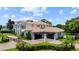 Expansive home featuring a porte cochere, well-maintained grounds, and an inviting entrance, ideal for entertaining at 2211 Azalea Pl, Winter Park, FL 32789