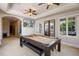 Spacious game room with a pool table, a TV, and a door leading to an outdoor balcony at 2211 Azalea Pl, Winter Park, FL 32789