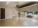 Spacious garage with epoxy flooring and ample room for storage, featuring a connecting door and car at 2211 Azalea Pl, Winter Park, FL 32789