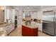 Kitchen boasts stainless appliances, custom cabinets, granite countertops, and a center island with seating at 2211 Azalea Pl, Winter Park, FL 32789
