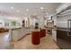 A spacious kitchen with stainless steel appliances, a center island, and granite countertops at 2211 Azalea Pl, Winter Park, FL 32789