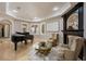 Cozy living room featuring a grand piano, fireplace, and comfortable seating at 2211 Azalea Pl, Winter Park, FL 32789