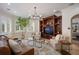 Cozy living room features a decorative chandelier, built-in shelves, and comfortable seating at 2211 Azalea Pl, Winter Park, FL 32789