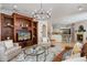 Spacious living room with a fireplace, open to the kitchen, and featuring an elegant built-in media center at 2211 Azalea Pl, Winter Park, FL 32789