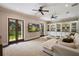 Spacious living room with French doors, built-in shelving, and a large, plush sofa for comfortable seating at 2211 Azalea Pl, Winter Park, FL 32789